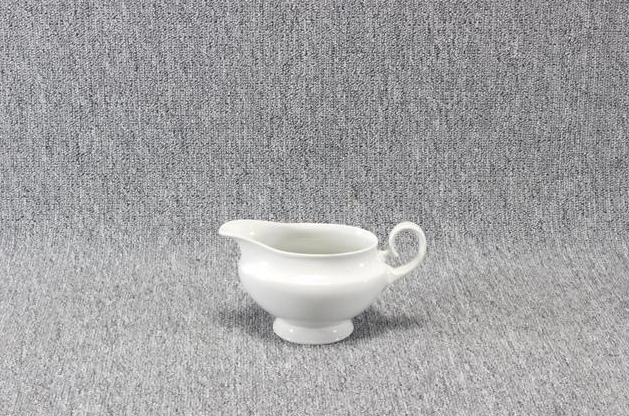 Eight shirts arranged on table in black, olive, grey, blue, white, red, mustard, and green.