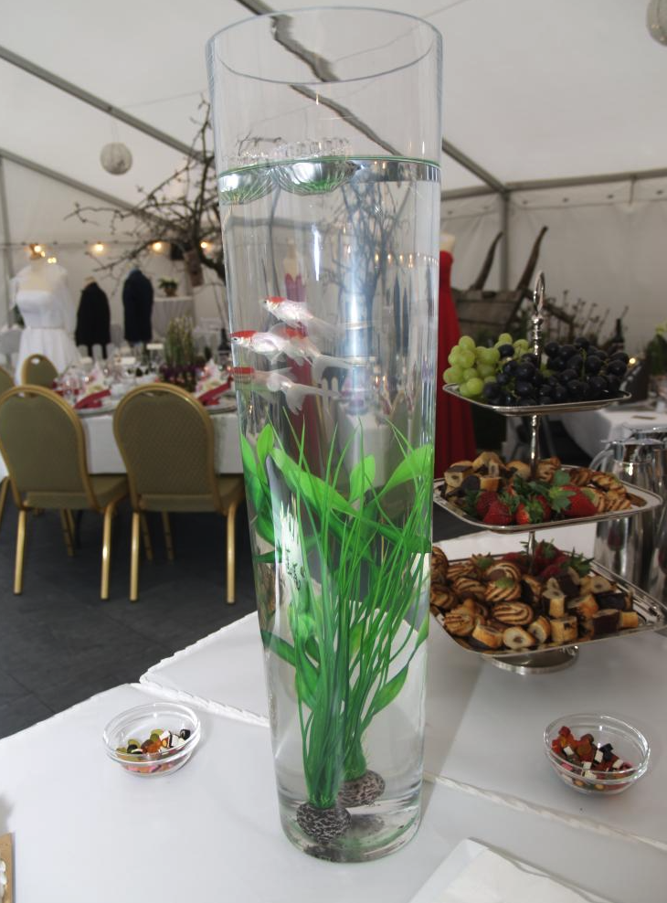 Eight shirts arranged on table in black, olive, grey, blue, white, red, mustard, and green.
