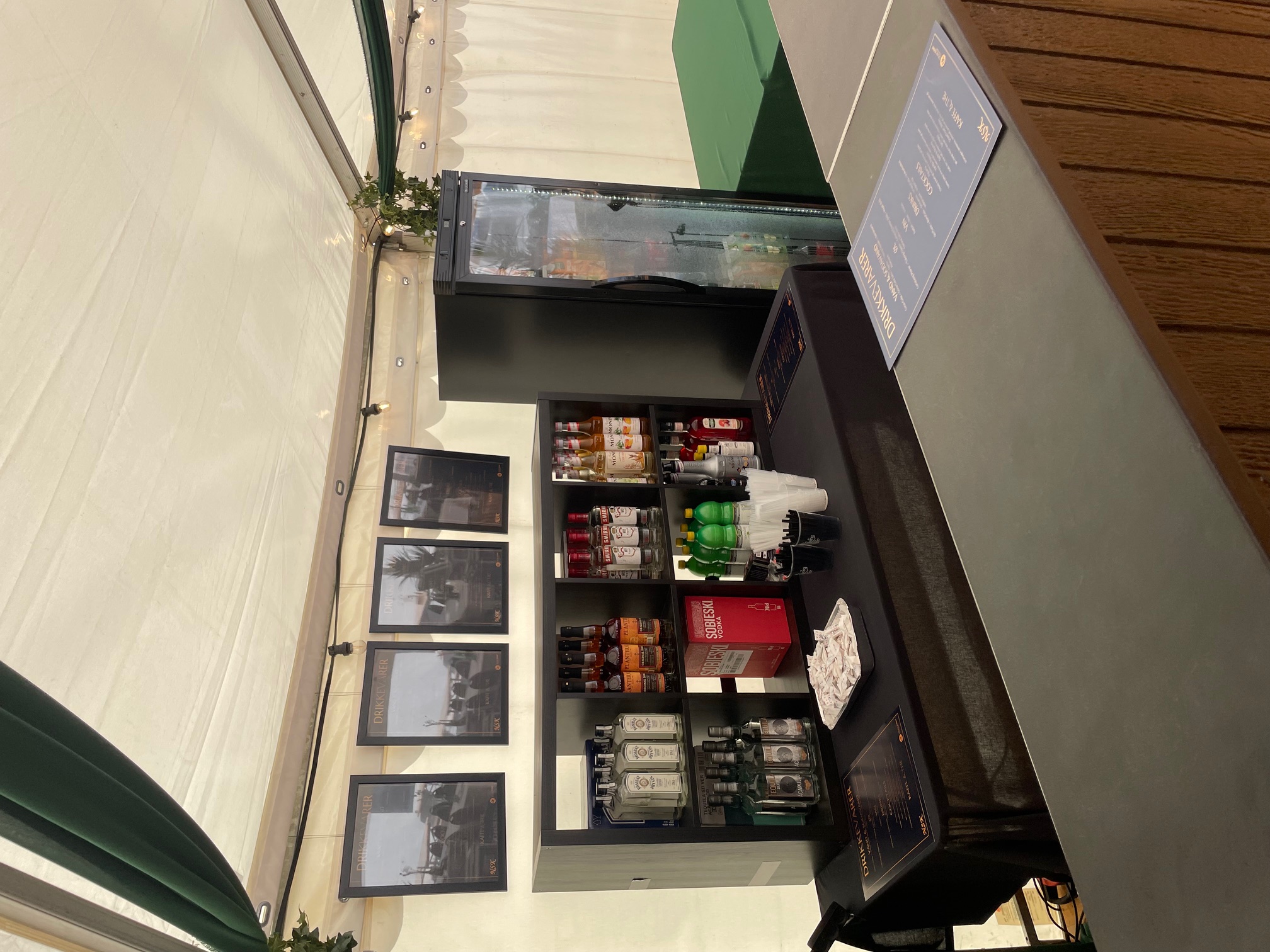 Eight shirts arranged on table in black, olive, grey, blue, white, red, mustard, and green.