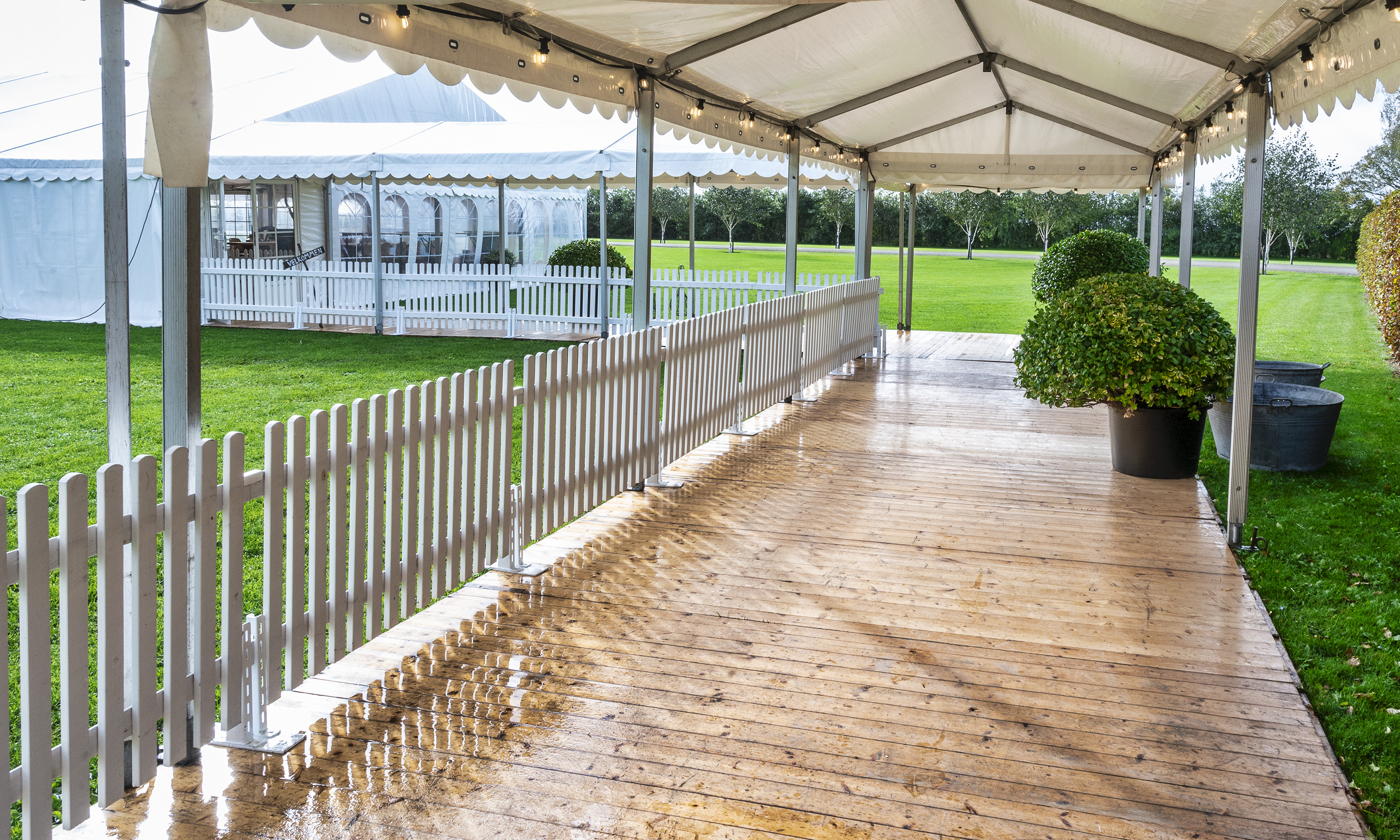Eight shirts arranged on table in black, olive, grey, blue, white, red, mustard, and green.