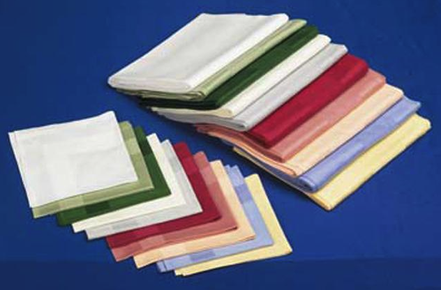 Eight shirts arranged on table in black, olive, grey, blue, white, red, mustard, and green.