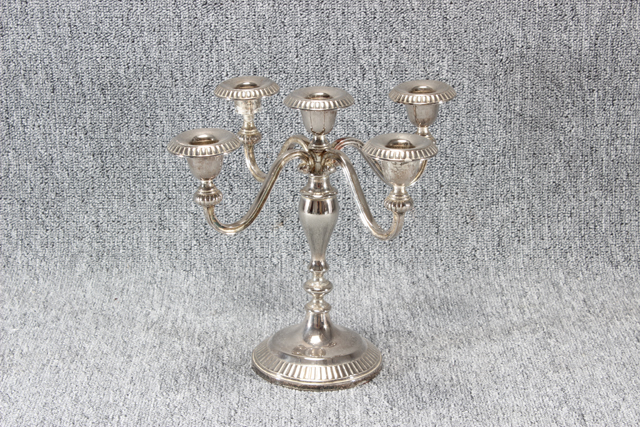 Eight shirts arranged on table in black, olive, grey, blue, white, red, mustard, and green.