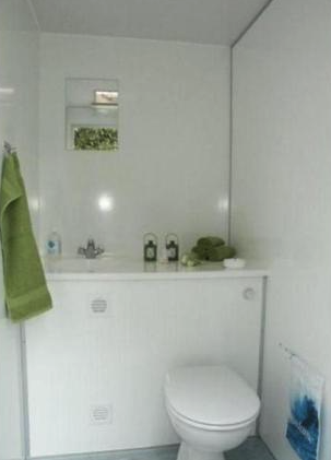 Eight shirts arranged on table in black, olive, grey, blue, white, red, mustard, and green.