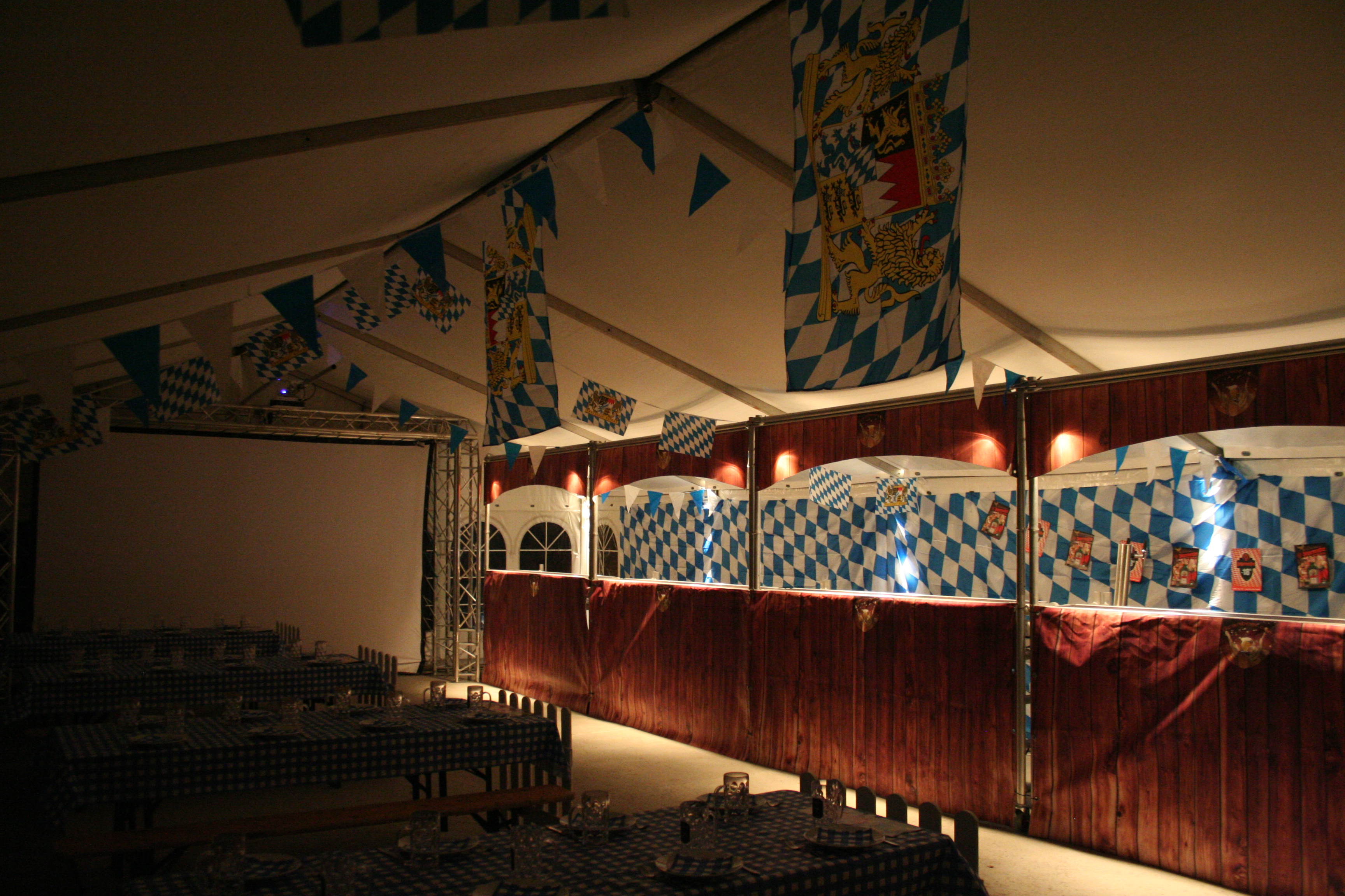 Eight shirts arranged on table in black, olive, grey, blue, white, red, mustard, and green.