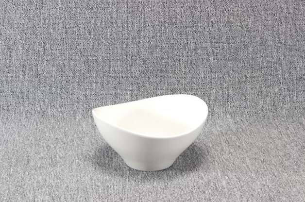 Eight shirts arranged on table in black, olive, grey, blue, white, red, mustard, and green.