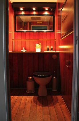 Eight shirts arranged on table in black, olive, grey, blue, white, red, mustard, and green.