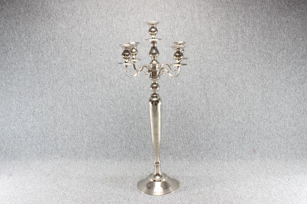 Eight shirts arranged on table in black, olive, grey, blue, white, red, mustard, and green.