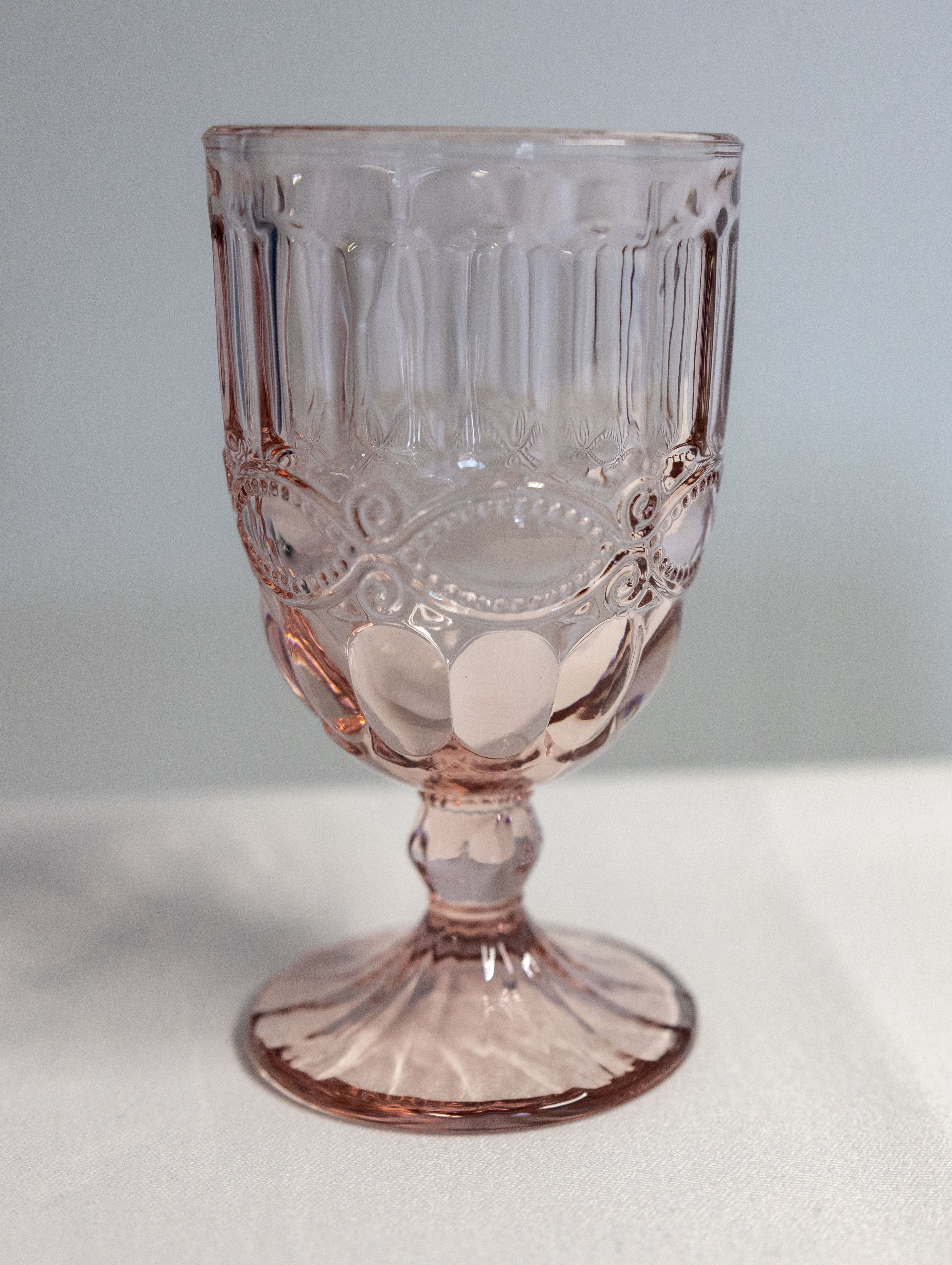 Eight shirts arranged on table in black, olive, grey, blue, white, red, mustard, and green.