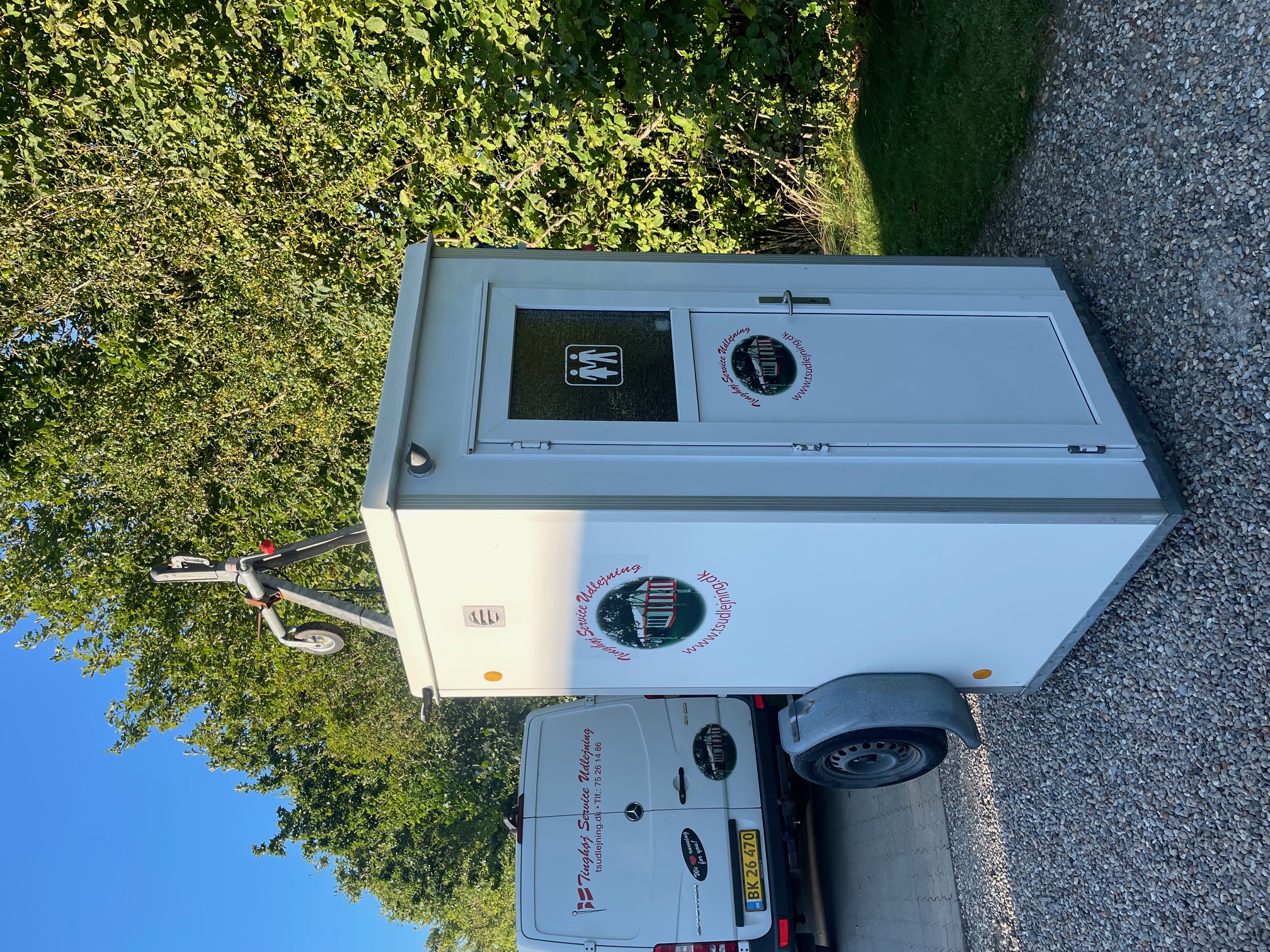 Eight shirts arranged on table in black, olive, grey, blue, white, red, mustard, and green.