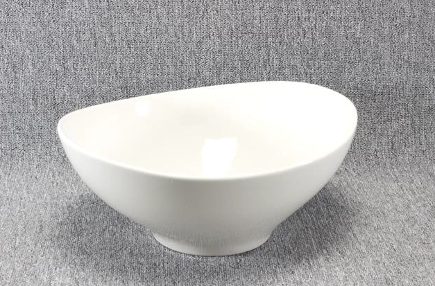 Eight shirts arranged on table in black, olive, grey, blue, white, red, mustard, and green.