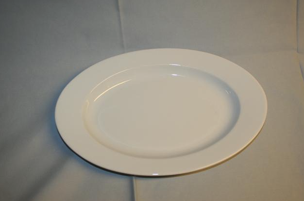 Eight shirts arranged on table in black, olive, grey, blue, white, red, mustard, and green.