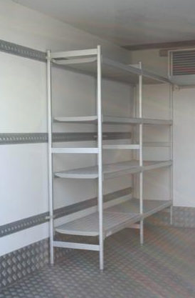 Eight shirts arranged on table in black, olive, grey, blue, white, red, mustard, and green.