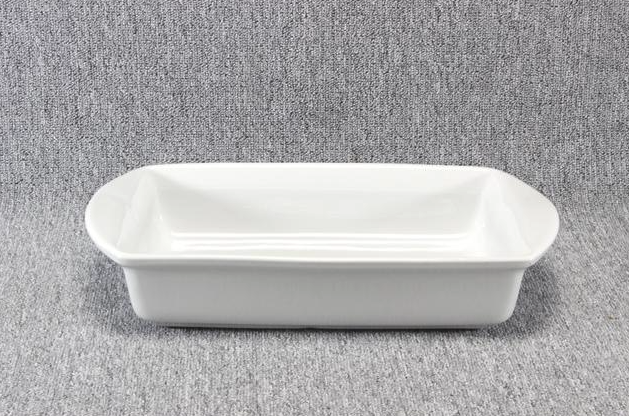 Eight shirts arranged on table in black, olive, grey, blue, white, red, mustard, and green.