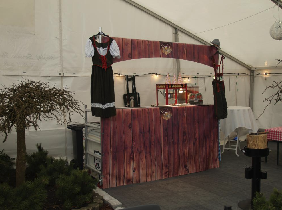 Eight shirts arranged on table in black, olive, grey, blue, white, red, mustard, and green.