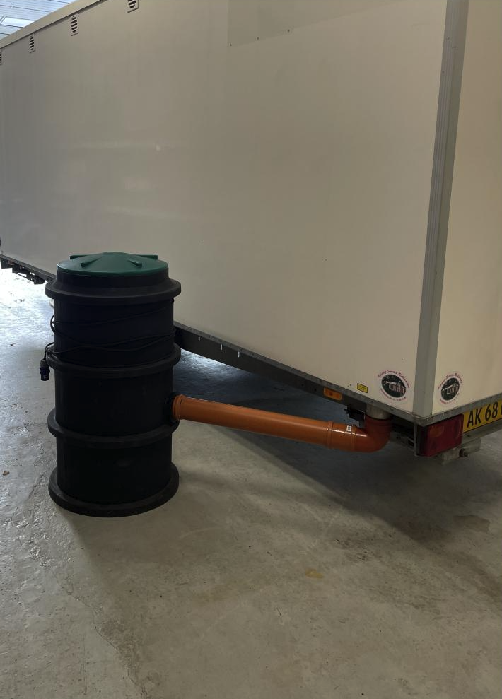Eight shirts arranged on table in black, olive, grey, blue, white, red, mustard, and green.