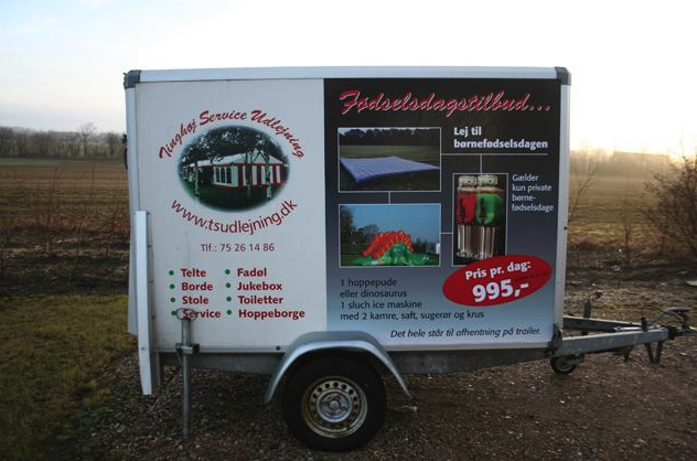 Eight shirts arranged on table in black, olive, grey, blue, white, red, mustard, and green.