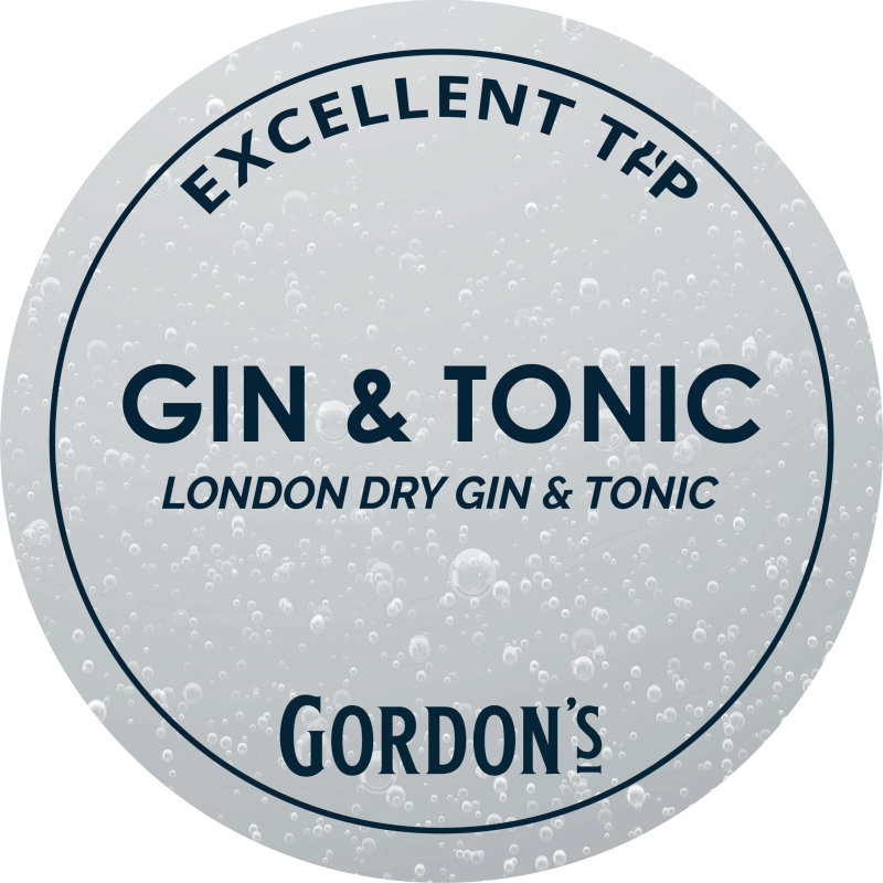 Eight shirts arranged on table in black, olive, grey, blue, white, red, mustard, and green.