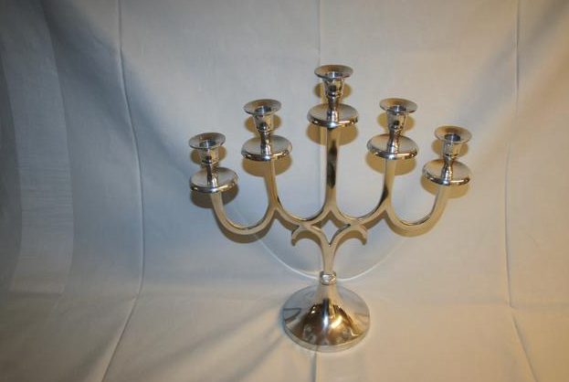 Eight shirts arranged on table in black, olive, grey, blue, white, red, mustard, and green.