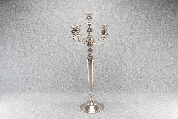 Eight shirts arranged on table in black, olive, grey, blue, white, red, mustard, and green.