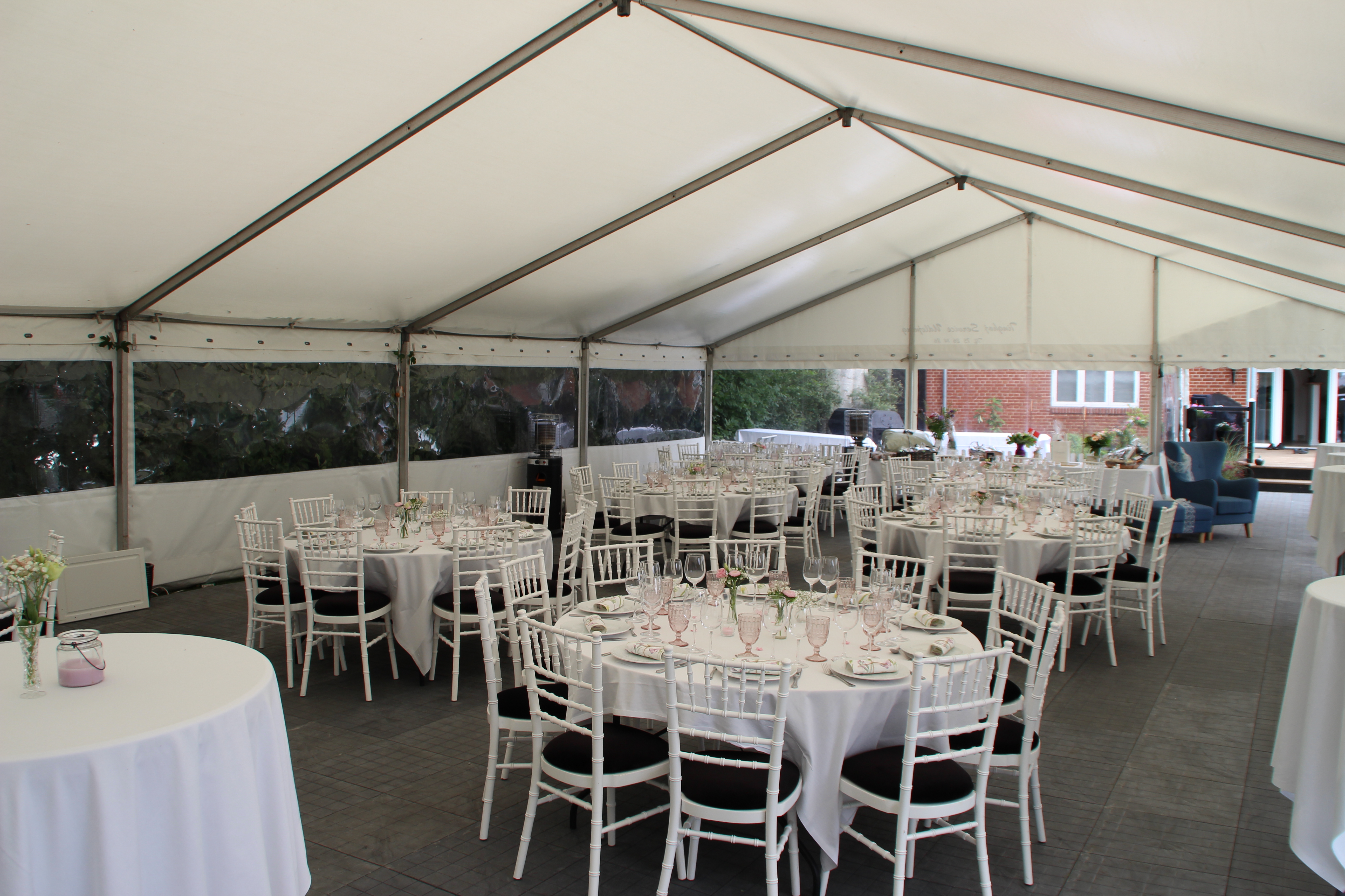 Eight shirts arranged on table in black, olive, grey, blue, white, red, mustard, and green.