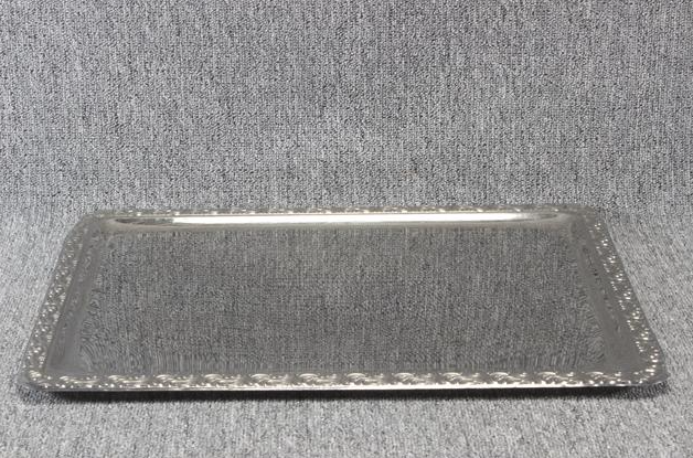 Eight shirts arranged on table in black, olive, grey, blue, white, red, mustard, and green.