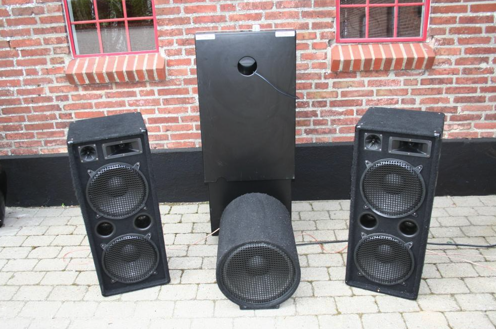 Eight shirts arranged on table in black, olive, grey, blue, white, red, mustard, and green.