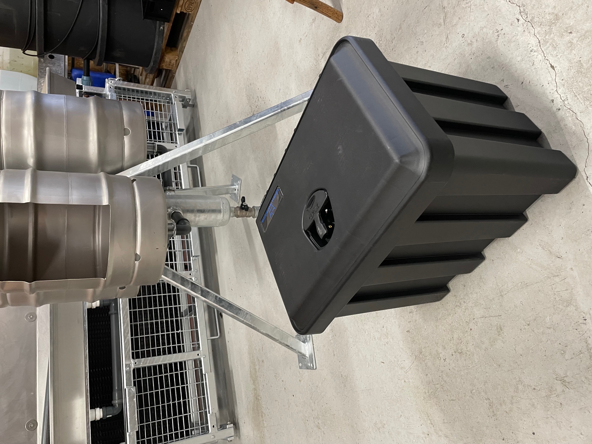 Eight shirts arranged on table in black, olive, grey, blue, white, red, mustard, and green.