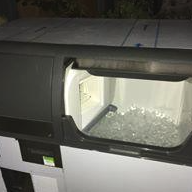 Eight shirts arranged on table in black, olive, grey, blue, white, red, mustard, and green.