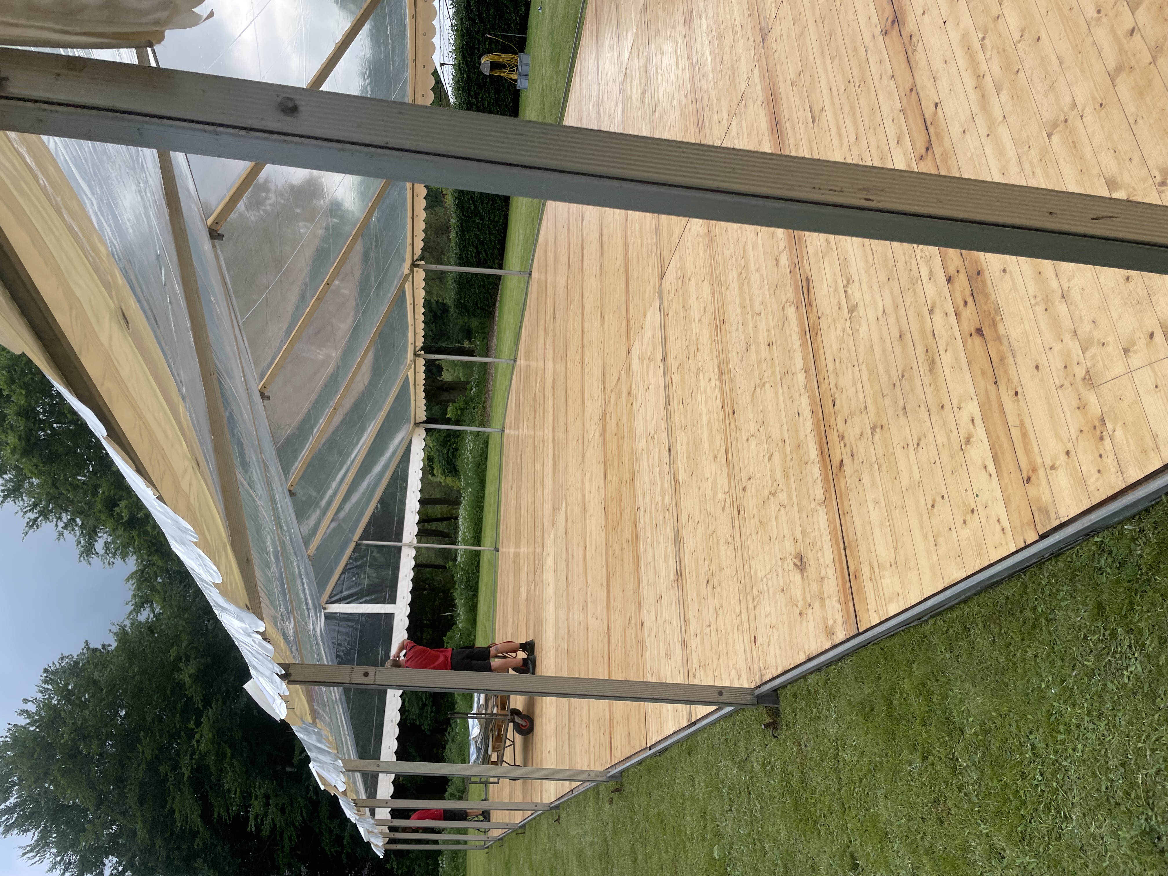 Eight shirts arranged on table in black, olive, grey, blue, white, red, mustard, and green.
