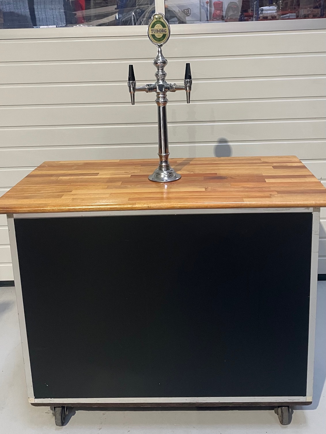 Eight shirts arranged on table in black, olive, grey, blue, white, red, mustard, and green.