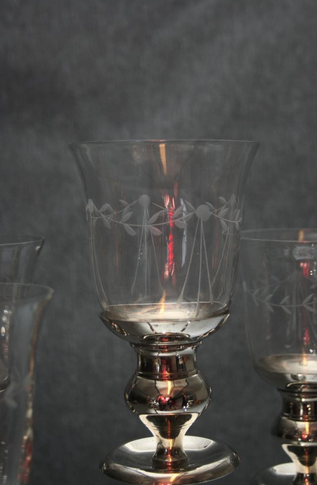 Eight shirts arranged on table in black, olive, grey, blue, white, red, mustard, and green.