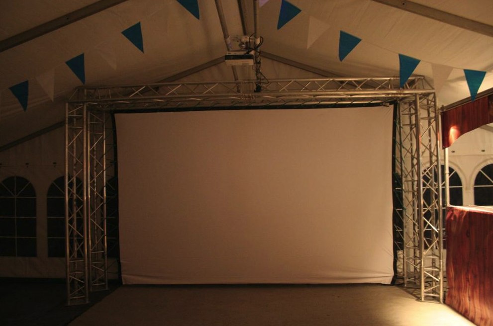 Eight shirts arranged on table in black, olive, grey, blue, white, red, mustard, and green.