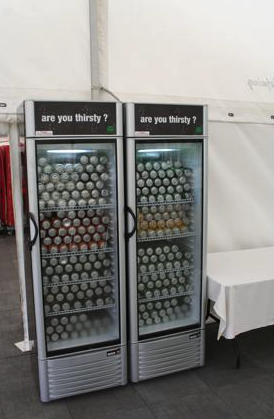 Eight shirts arranged on table in black, olive, grey, blue, white, red, mustard, and green.
