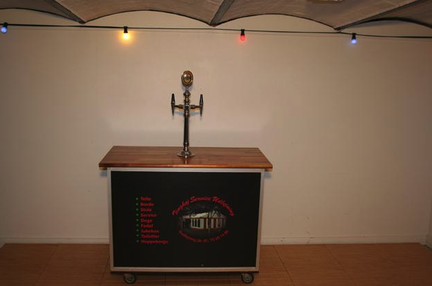 Eight shirts arranged on table in black, olive, grey, blue, white, red, mustard, and green.