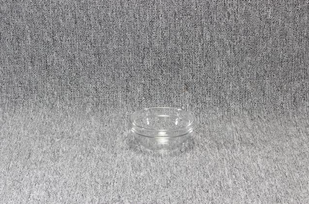 Eight shirts arranged on table in black, olive, grey, blue, white, red, mustard, and green.