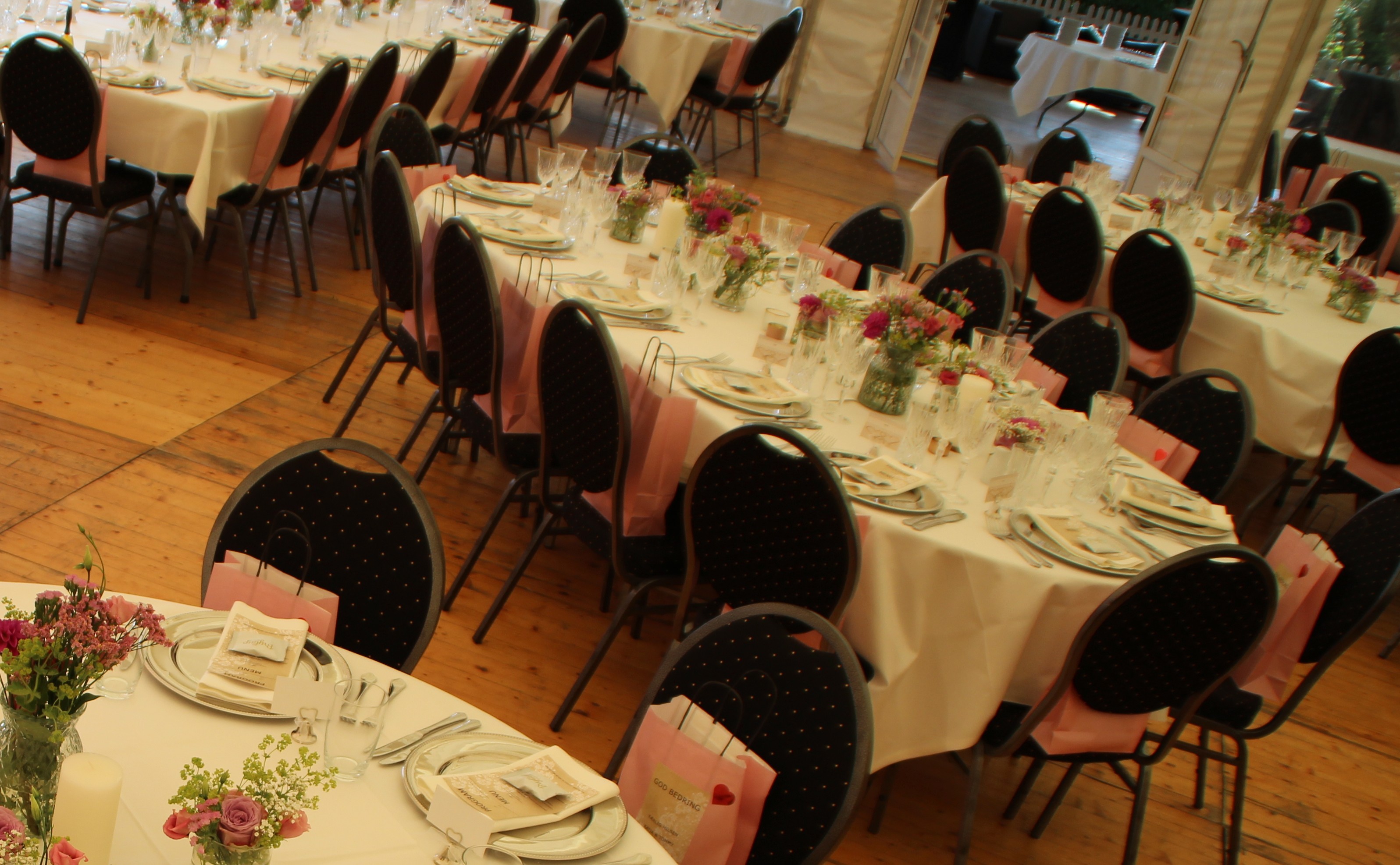 Eight shirts arranged on table in black, olive, grey, blue, white, red, mustard, and green.