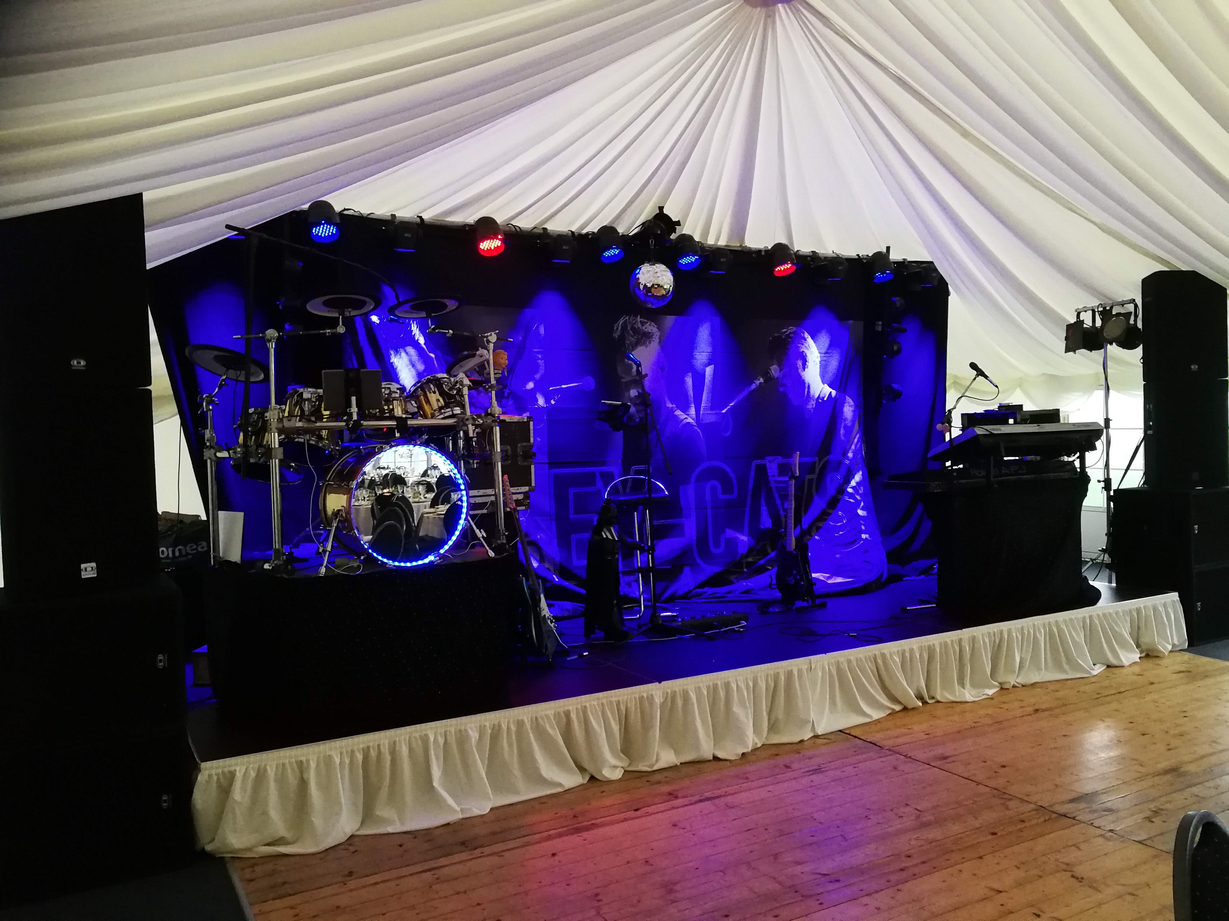 Eight shirts arranged on table in black, olive, grey, blue, white, red, mustard, and green.