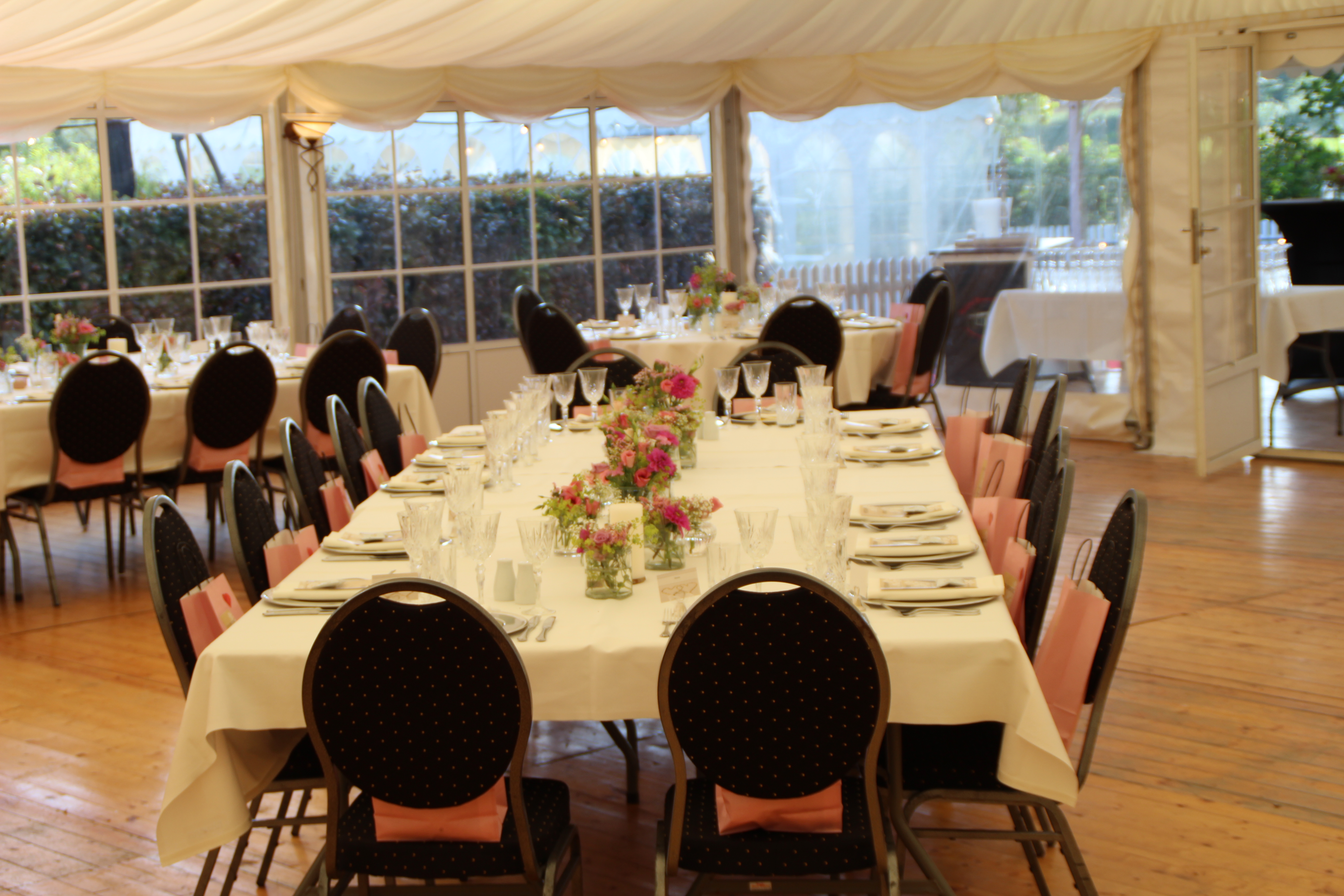 Eight shirts arranged on table in black, olive, grey, blue, white, red, mustard, and green.