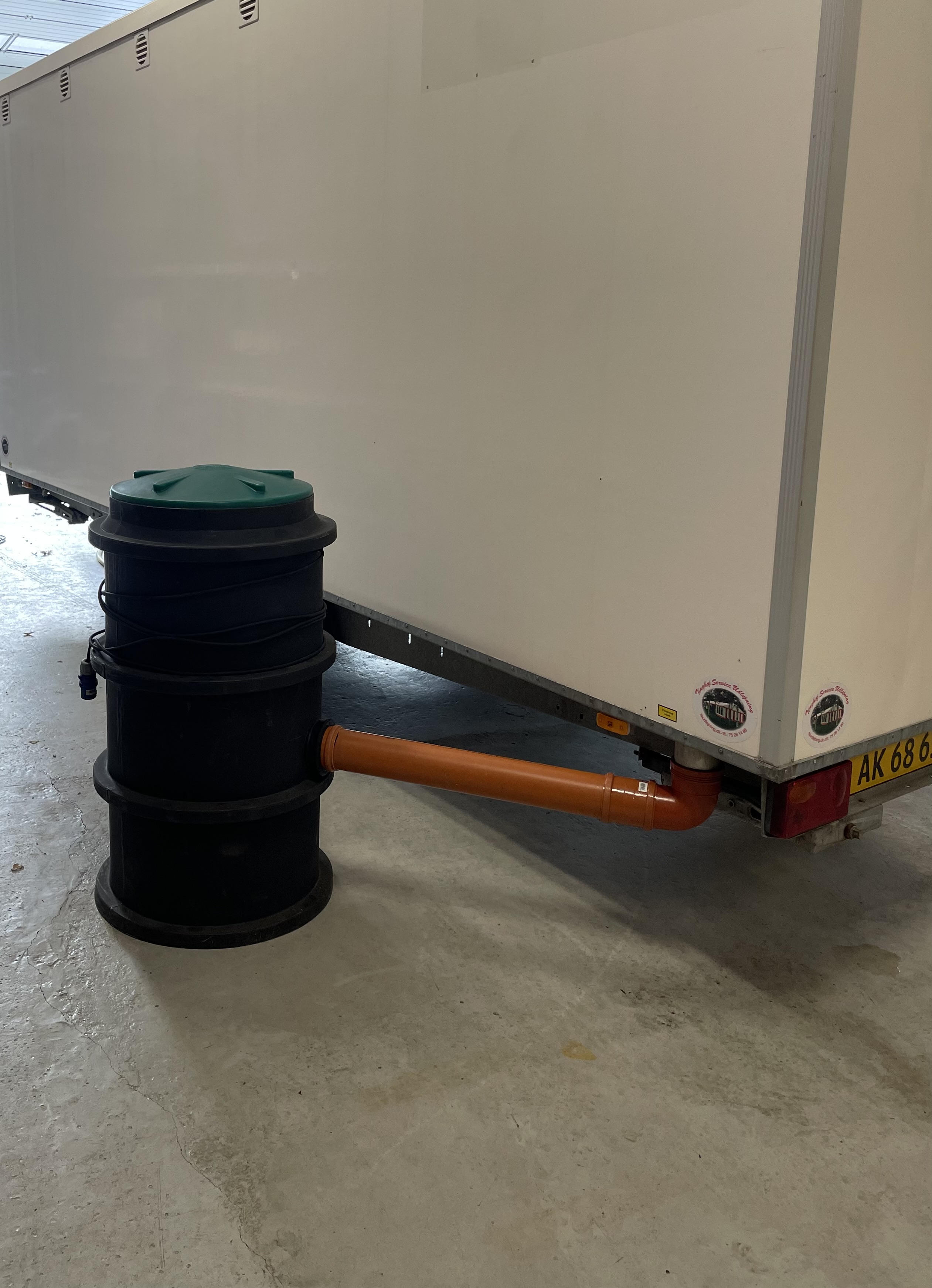 Eight shirts arranged on table in black, olive, grey, blue, white, red, mustard, and green.