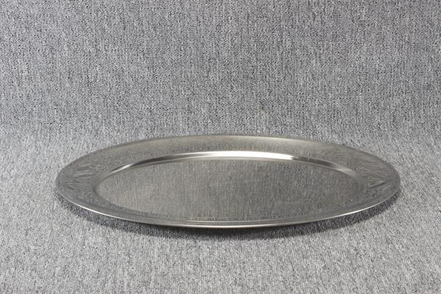 Eight shirts arranged on table in black, olive, grey, blue, white, red, mustard, and green.