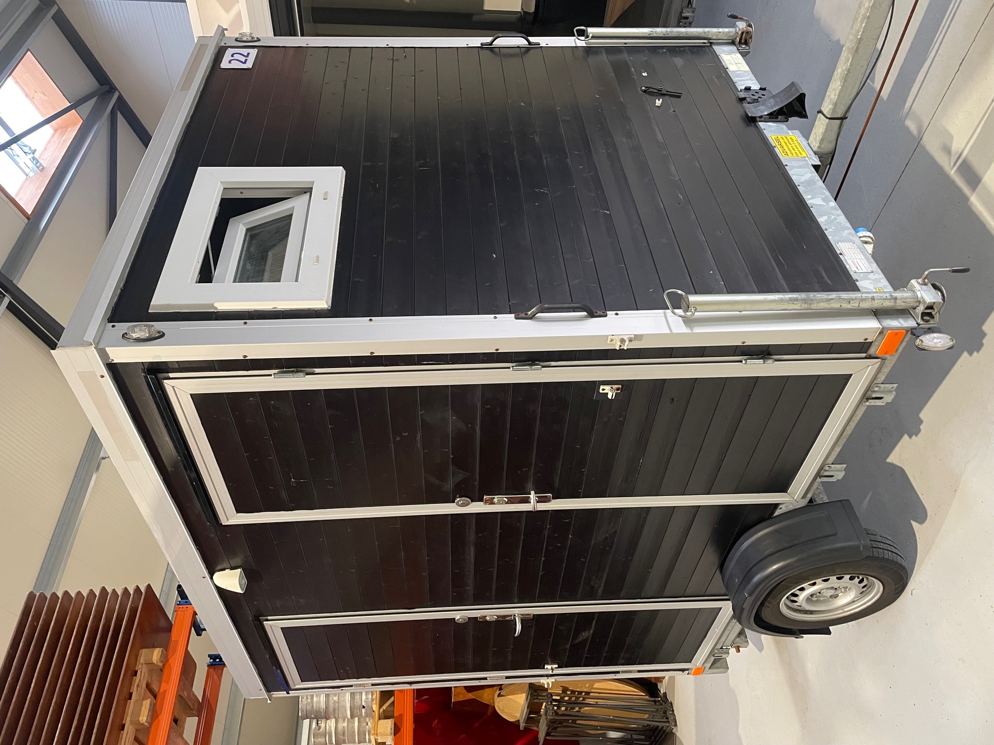 Eight shirts arranged on table in black, olive, grey, blue, white, red, mustard, and green.