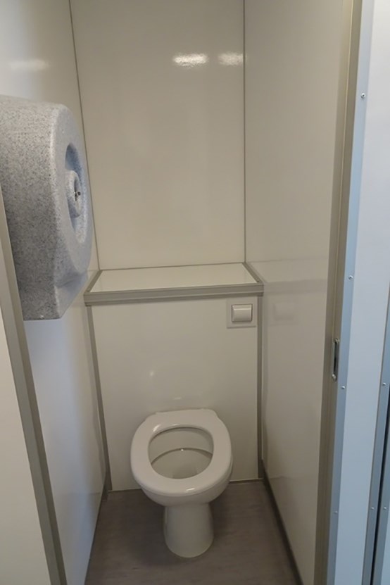 Eight shirts arranged on table in black, olive, grey, blue, white, red, mustard, and green.