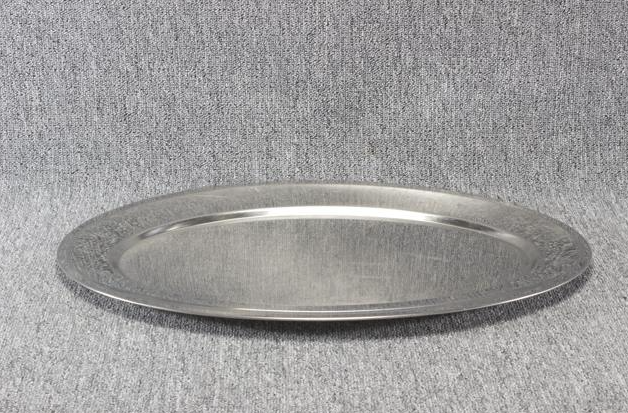 Eight shirts arranged on table in black, olive, grey, blue, white, red, mustard, and green.