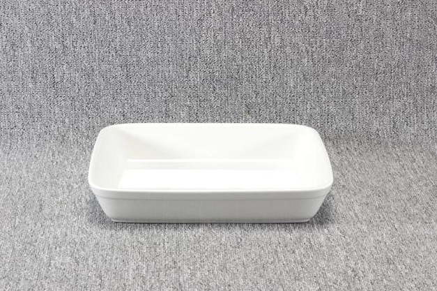 Eight shirts arranged on table in black, olive, grey, blue, white, red, mustard, and green.