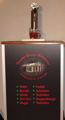 Eight shirts arranged on table in black, olive, grey, blue, white, red, mustard, and green.