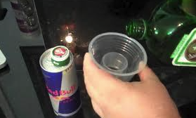 Eight shirts arranged on table in black, olive, grey, blue, white, red, mustard, and green.