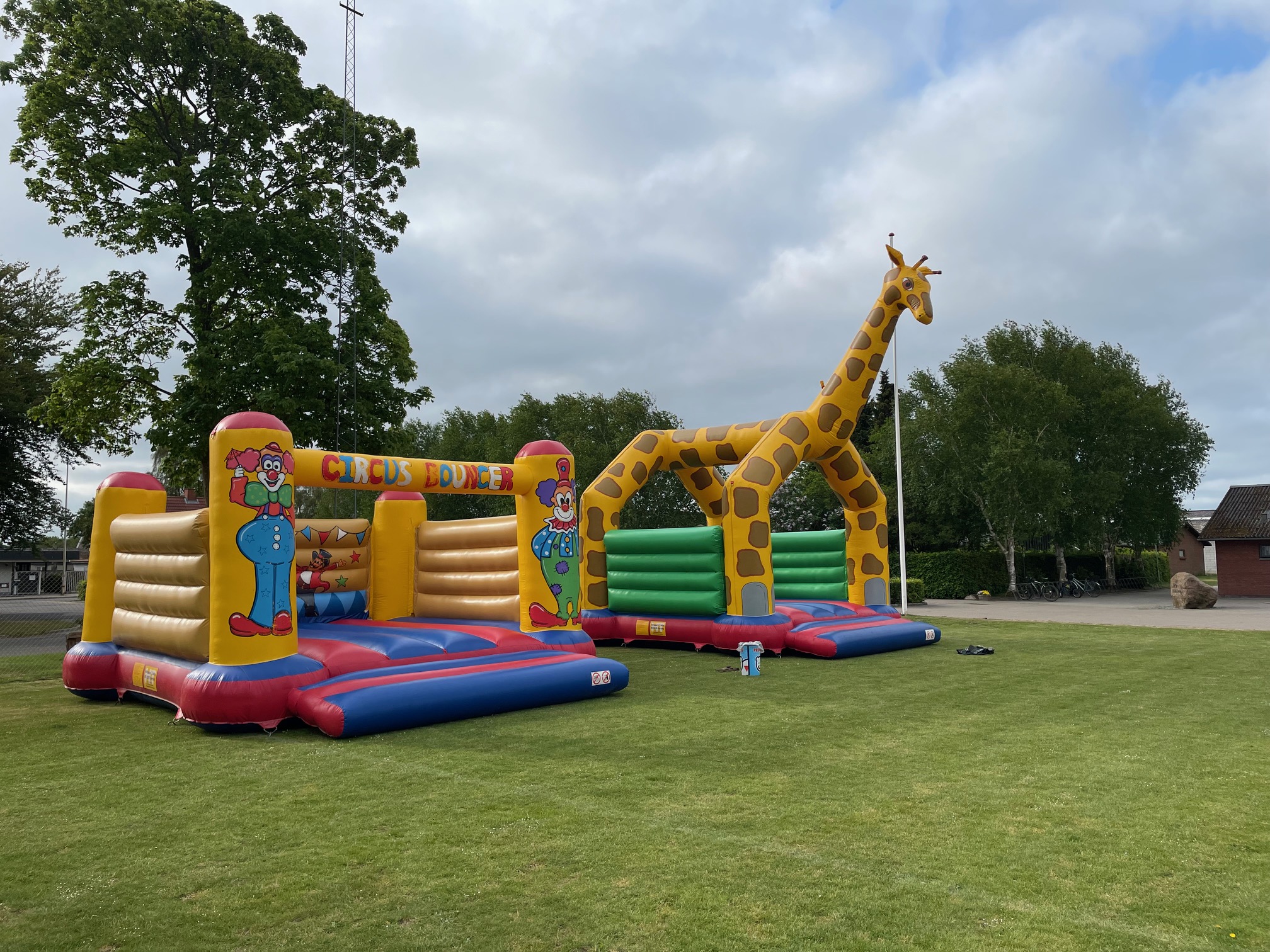 Eight shirts arranged on table in black, olive, grey, blue, white, red, mustard, and green.