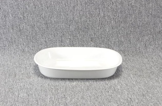 Eight shirts arranged on table in black, olive, grey, blue, white, red, mustard, and green.