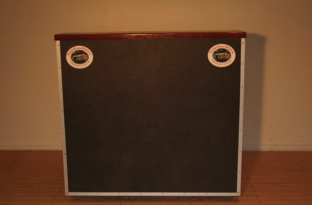 Eight shirts arranged on table in black, olive, grey, blue, white, red, mustard, and green.