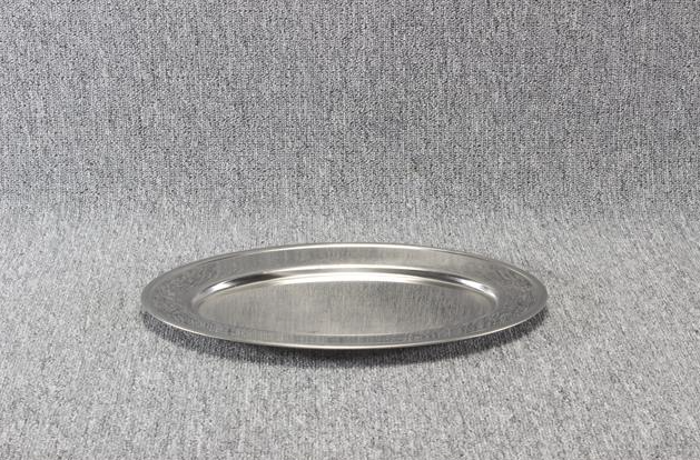 Eight shirts arranged on table in black, olive, grey, blue, white, red, mustard, and green.